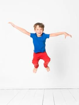 Cool boy is jumping in front of white background Stock Photos