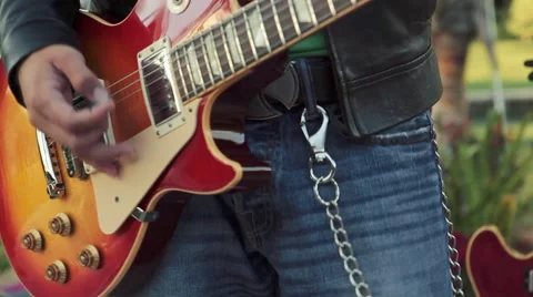 Cool close-up of guitar player's hands playing electric guitar during the day Stock Footage 54792867