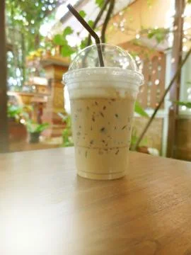 Cool coffee in a glass placed on the table. Stock Photos