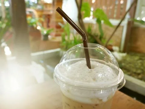 Cool coffee in a glass placed on the table. Stock Photos