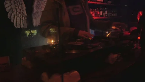 Cool dj behind the turntables performing in a bar Video stock 86366752