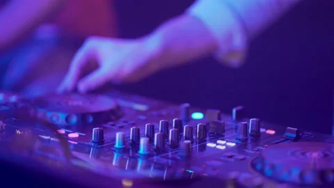A cool dj standing at the mixer controller, composing music mix and rocking the Stock Footage 167261824