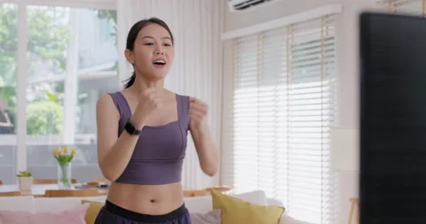 Cool down after finish exercise on online gym workout at cozy home. Stock Footage 230855611