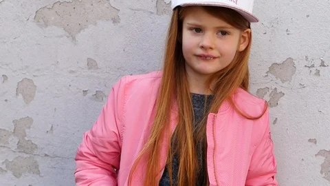 Cool girl by wall Stock Footage 86348387