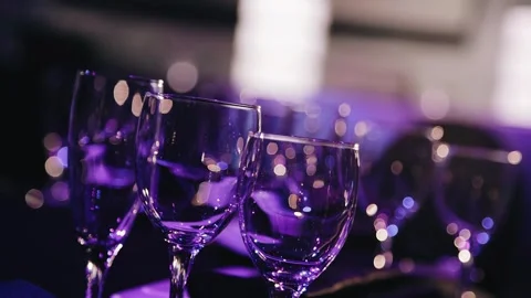 Cool glasses are on the table and illuminated by cool light Stock Footage 259296835