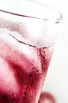 Cool grape juice for refreshment on isolated white background. Stock Photos