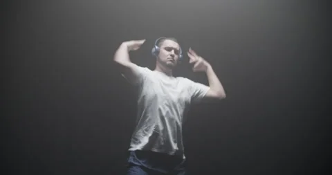 Cool guy appearing and dancing hip hop in spotlight Stock Footage 244525645