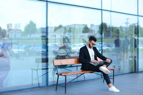 Cool guy arabic man uses laptop business center Stock-Fotos