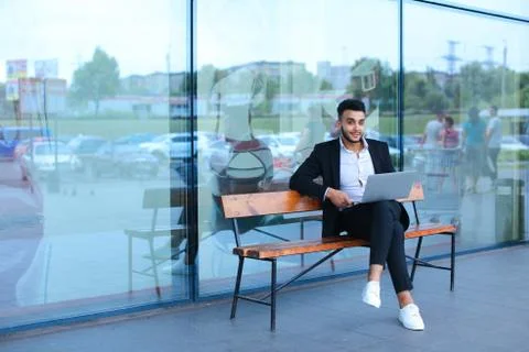 Cool guy arabic man uses laptop business center Foto stock