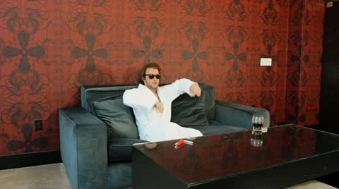 Cool guy on couch V1 - HD Stock Footage 12229893