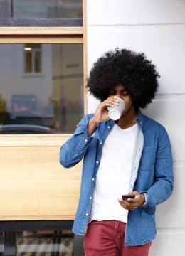 Cool guy drinking coffee and using cellphone Stock Photos