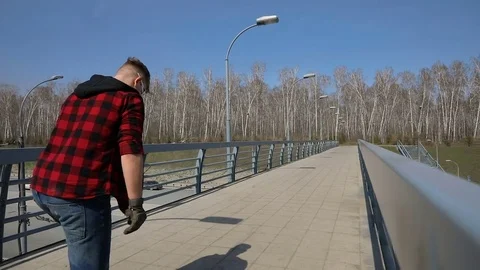 Cool guy on his longboard skate Over the bridge Stock Footage 74979280