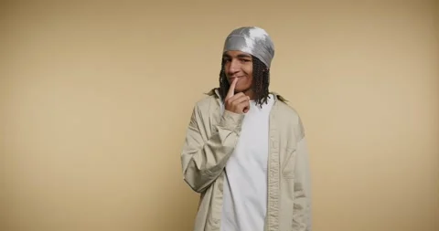 Cool guy shows fun expressions and playful gestures in a warm studio settin.. Vídeo Stock 329111762