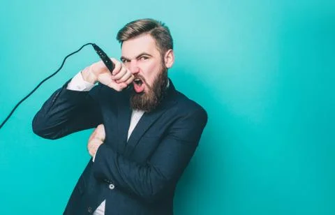 Cool guy is singing. He likes to sing in microphone. Man is loking to the camera Stockfoto's