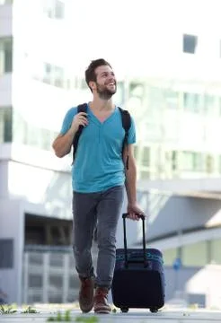 Cool guy smiling with suitcase and bag Foto stock