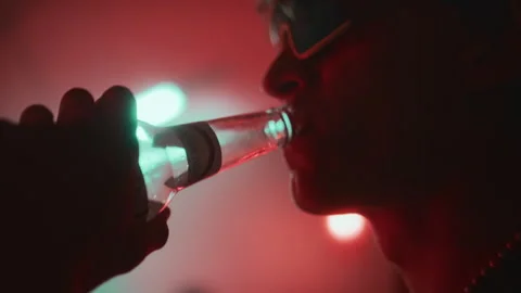 Cool Guy in Techno Rave Glasses Taking MDMA with Beer in Nightclub Stock Footage 279963793