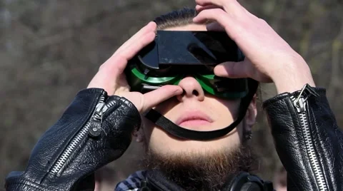 Cool guy watching the eclipse of the sun through the improvised materialylunoy Stock Footage 48217361