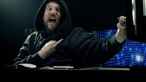 Cool hacker showing medium finger to screen sign of victory slow motion Stock Footage 86256439