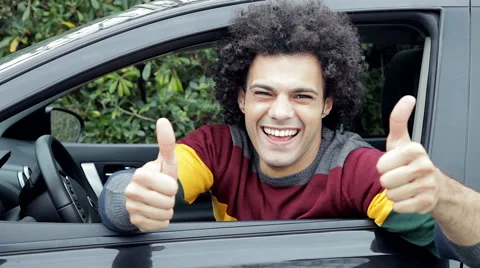 Cool handsome happy man thumb up and hello from car looking camera Stock Footage 49095424