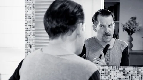 Cool handsome man singing in front of mirror with comb slow motion closeup Stock Footage 82208080