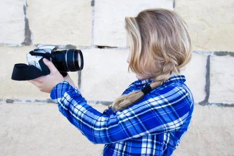 Cool kid holding a camera taking a photo of herself Stock Photos
