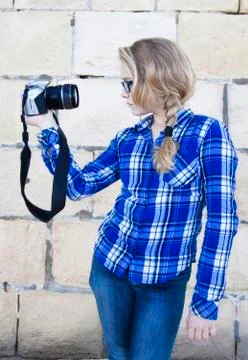 Cool kid holding a camera taking a photo of herself Stock Photos