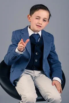 Cool kid in suit winking Stock Photos