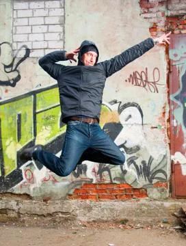 Cool looking dancer posing on a grunge background Stock Photos