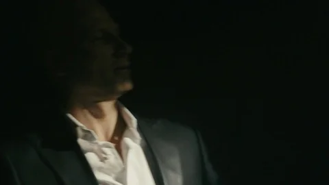 Cool looking guy dancing in the beam of light on a black background Stock-Footage 75235789