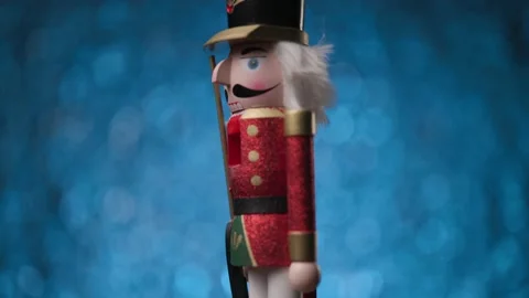 Cool looking Nutcracker is spinning on a bright blue background Stock Footage 321679486