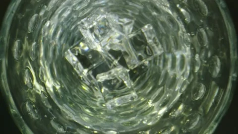 Cool macro shot going inside a clear glass with water and ice Stock Footage 131753231