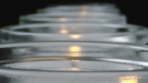 Cool macro shot moving right over row of white candles Stock Footage 132212307
