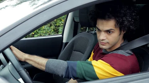 Cool man checking the rearview mirror before starting car Stock Footage 49432363