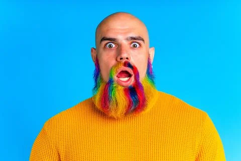 Cool man with colorful beard looking at camera and feeling amazing in studio Stock Photos