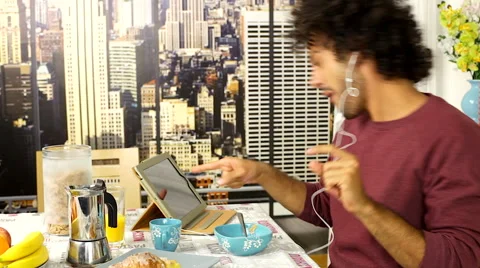 Cool man dancing during breakfast at home in New York Stock Footage 49940156