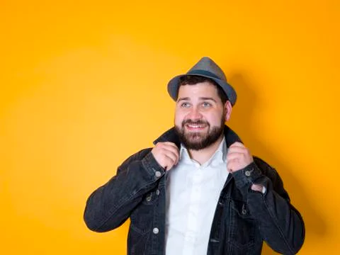 Cool man with hat in front of yellow, orange background Stock Photos