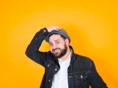 Cool man with hat in front of yellow, orange background Stock Photos