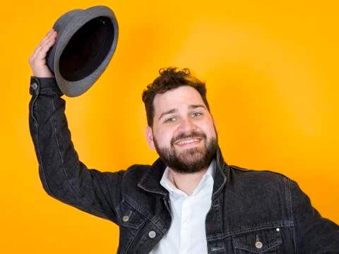 Cool man with hat in front of yellow, orange background Foto stock