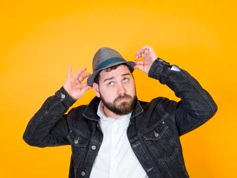 Cool man with hat in front of yellow, orange background Foto stock
