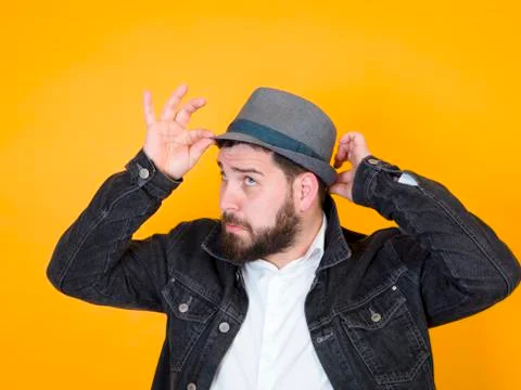 Cool man with hat in front of yellow, orange background Stock Photos