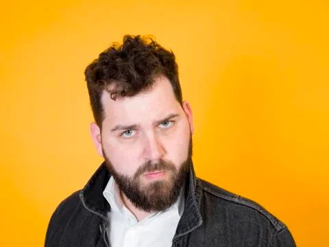 Cool man posing in front of orange background Stock Photos