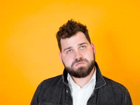 Cool man posing in front of orange background Stock Photos
