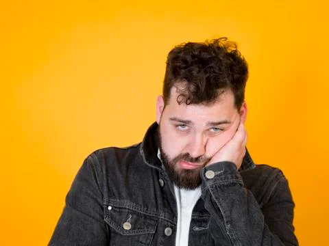 Cool man posing in front of orange background Stock Photos