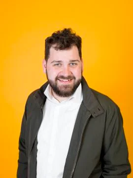 Cool man posing in front of orange background Foto stock