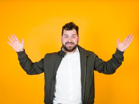 Cool man posing in front of orange background Stock Photos