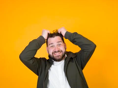 Cool man posing in front of orange background Stock Photos