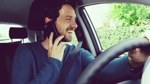 Cool man talking with cell in car while driving retro style Stock Footage 74750030