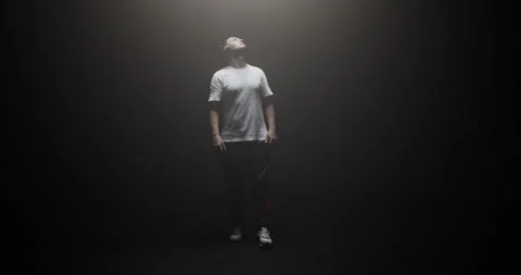 Cool man walking in spotlight and looking up Stock Footage 244524705