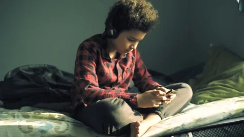 Cool mixed boy in the room  listening a music Stock-Footage 128999727