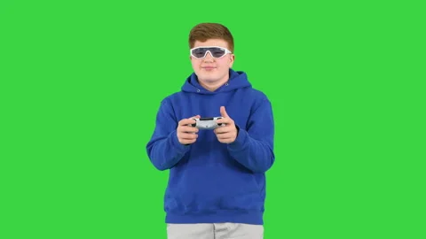 Cool modern kid playing video game in sunglasses on a Green Screen, Chroma Key. Stock Footage 147330971